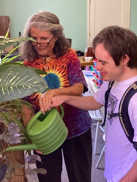 A client and staff water plants together